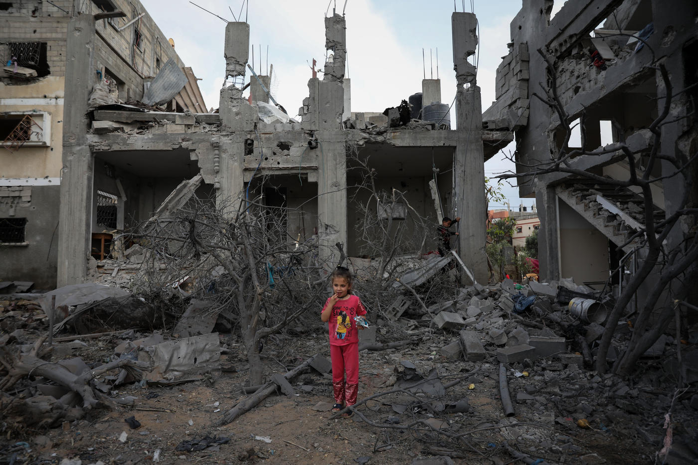 A child stands in the wreckage of her neighbourhood in the Gaza Strip following Israel's military bombing campaign in May 2021. (MEE/Mohammed al-Hajjar)