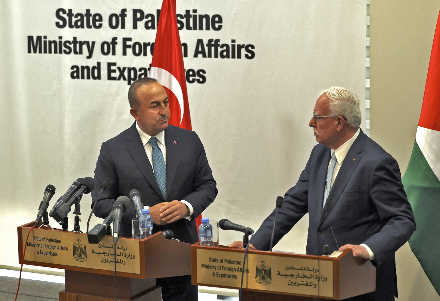 Palestinian Foreign Minister Riyad al-Maliki (R) and Turkish Foreign Minister Mevlut Cavusoglu attend a press conference after meeting in the city of Ramallah in the occupied West Bank on 24 May 2022 (AFP)