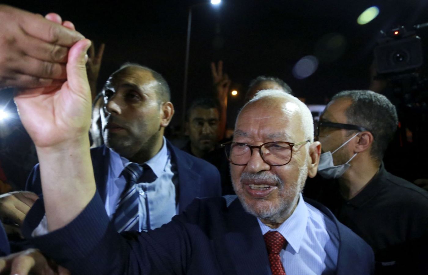 Rachid Ghannouchi, head of Tunisia's Islamist Ennahda party, greets his supporters as he leaves the office of Tunisia's counter-terrorism prosecutor in Tunis on July 19, 2022 (AFP)