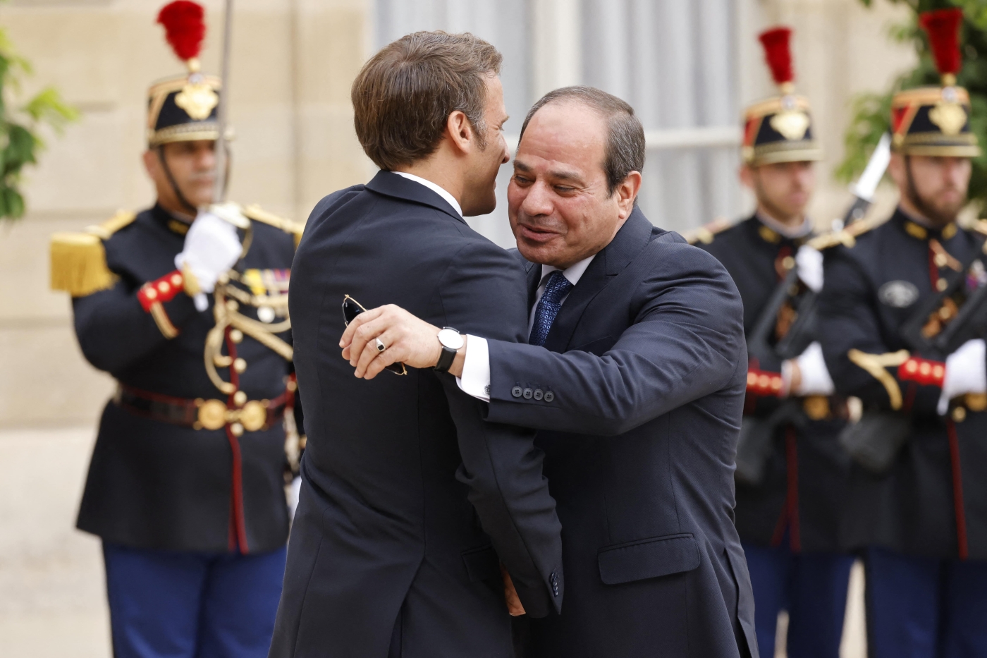 France's President Macron hugs Egypt's President Abdel Fattah el-Sisi (R) upon his arrival at the Elysee Palace in Paris on July 22, 2022 (AFP)