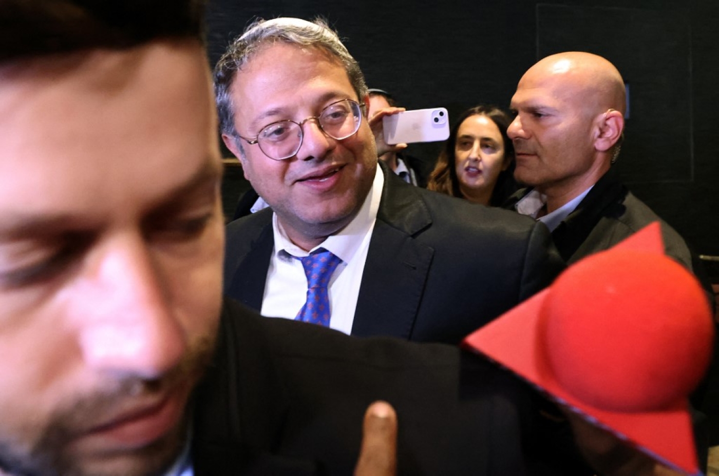 Leader of Israel's Jewish Power far-right party Itamar Ben Gvir speaks with supporters as he arrives to a hotel in Jerusalem before national election polls close on 1 November 2022 (AFP)