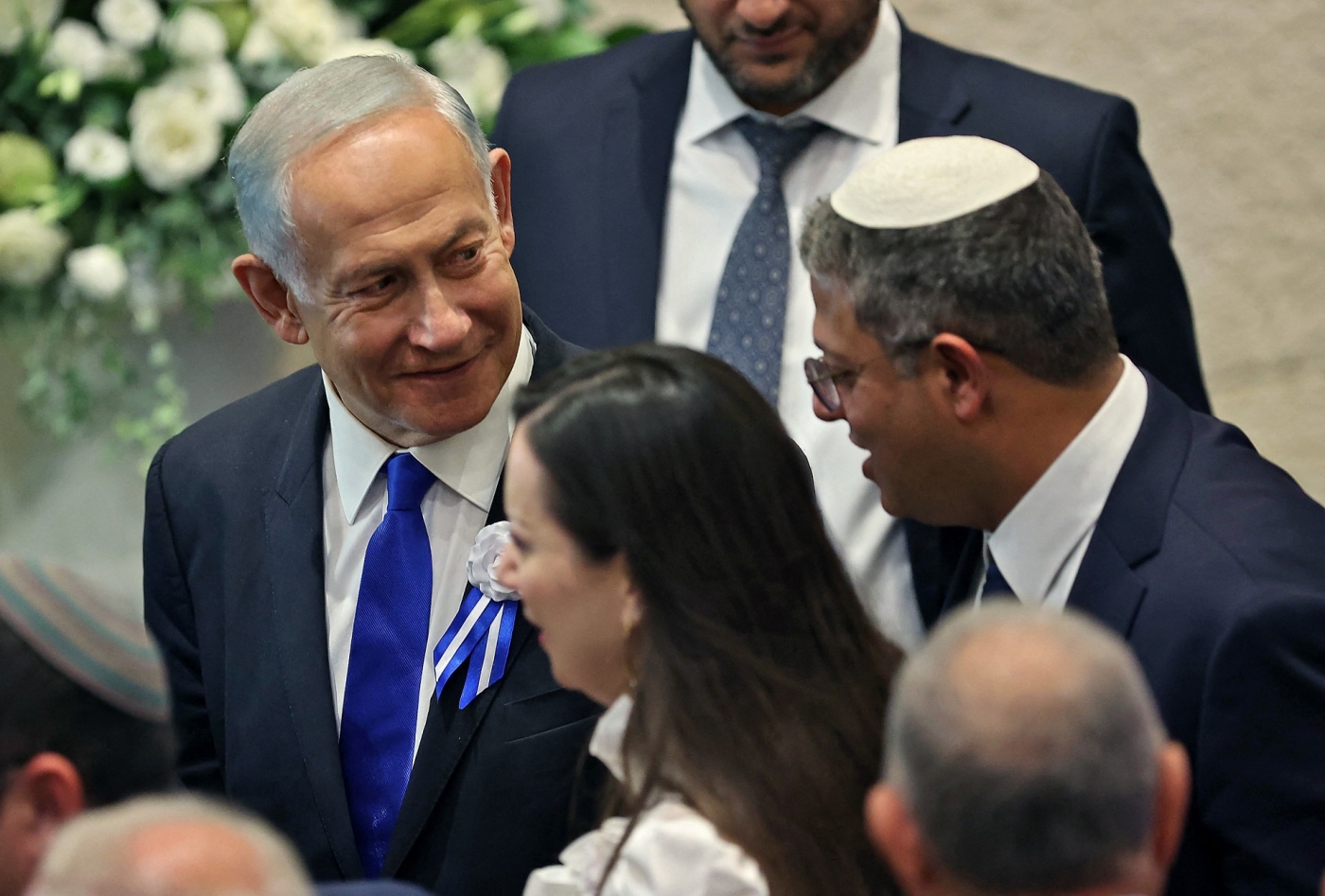 Itamar Ben-Gvir (R) chats with incoming Prime Minister Benjamin Netanyahu (L) during the swearing in ceremony of the new Israeli parliament in Jerusalem, on 15 November (AFP)