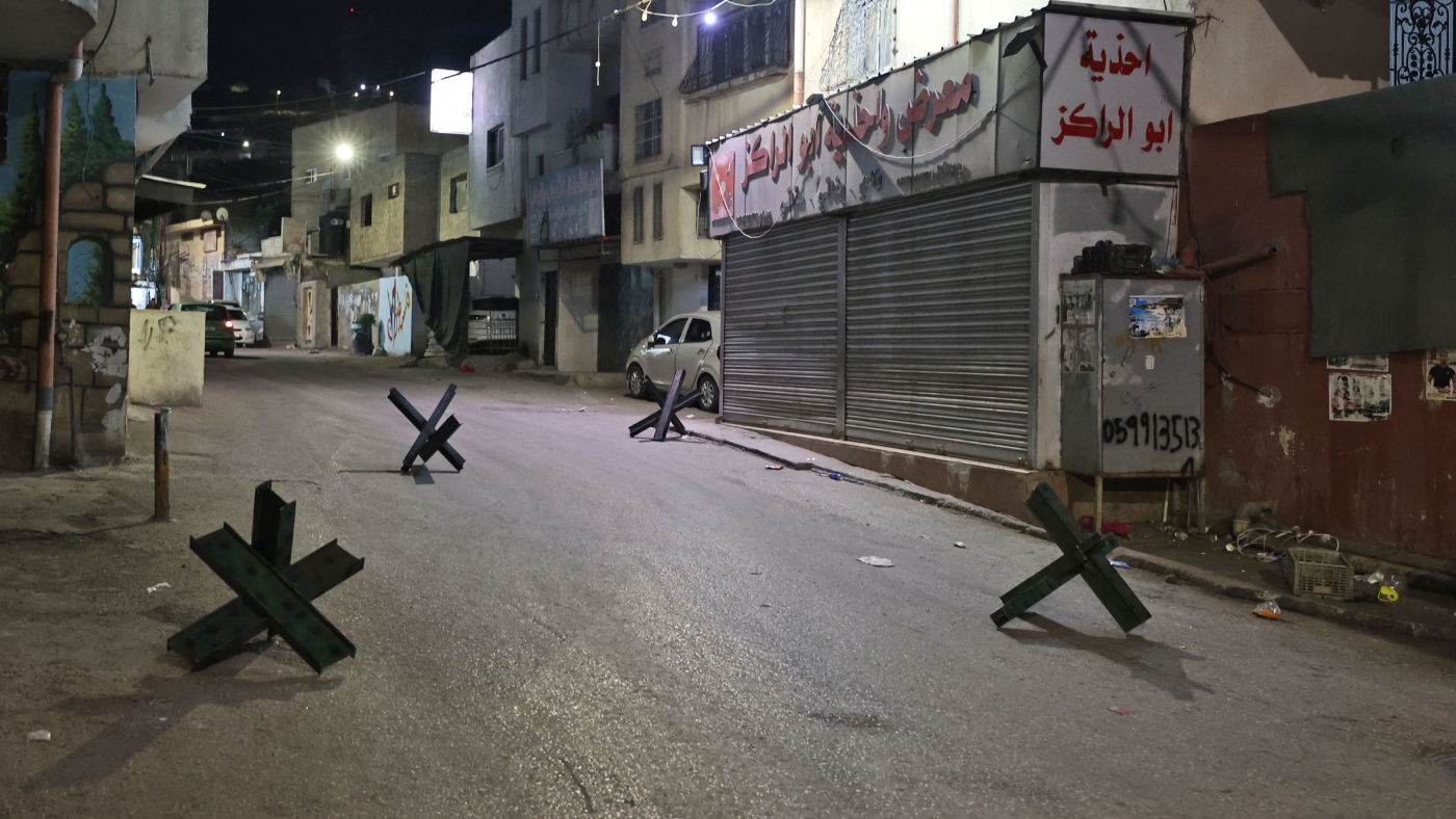 Metal bars block a street in the Jenin refugee camp in the occupied West Bank, early on 23 November 2022 (AFP)