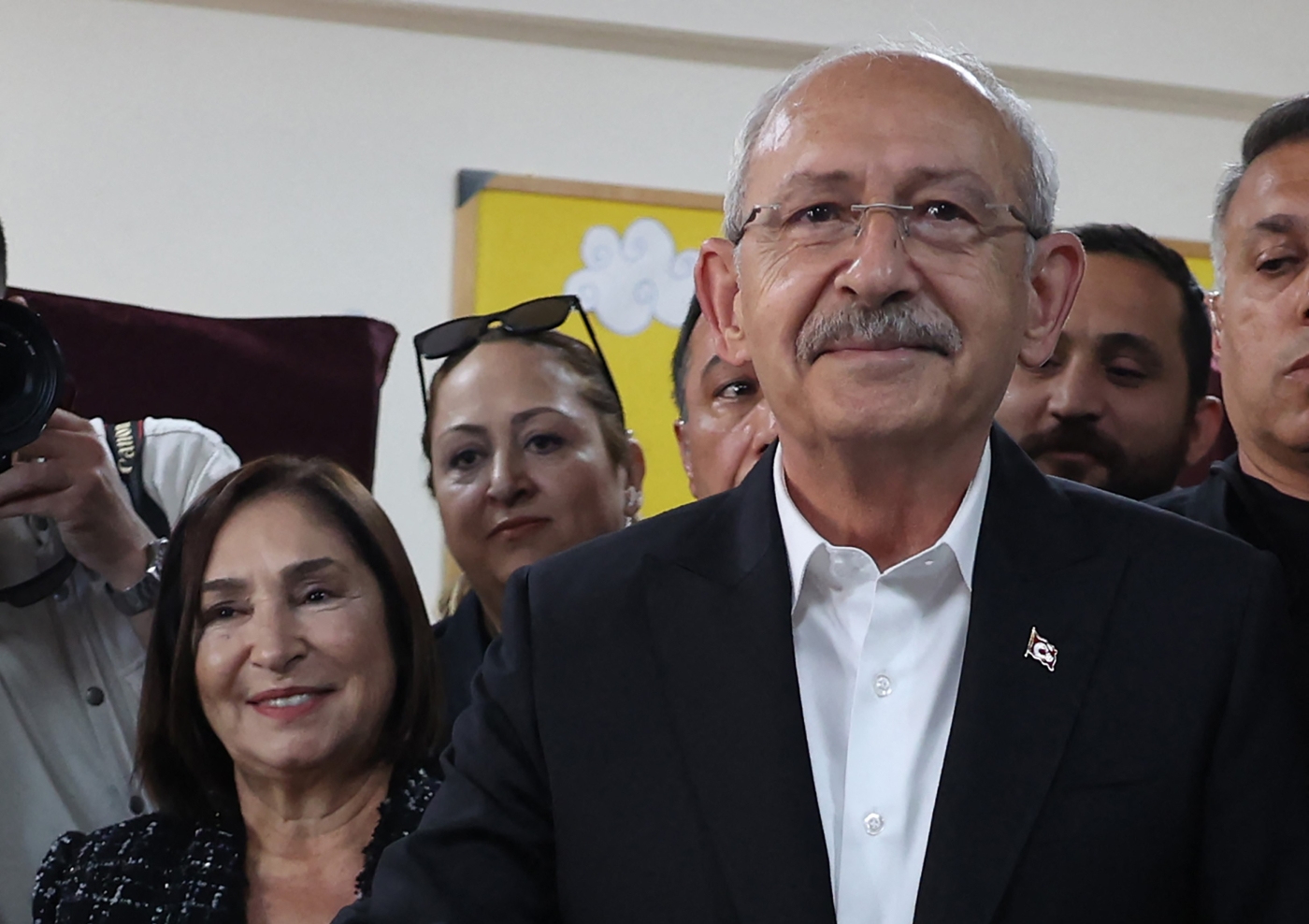 Kemal Kilicdaroglu (R) the 74-year-old leader of the Republican People's Party, or CHP, casts his vote next to his wife Selvi Kilicdaroglu (2L) at a polling station in Ankara on May 14, 2023 (AFP)