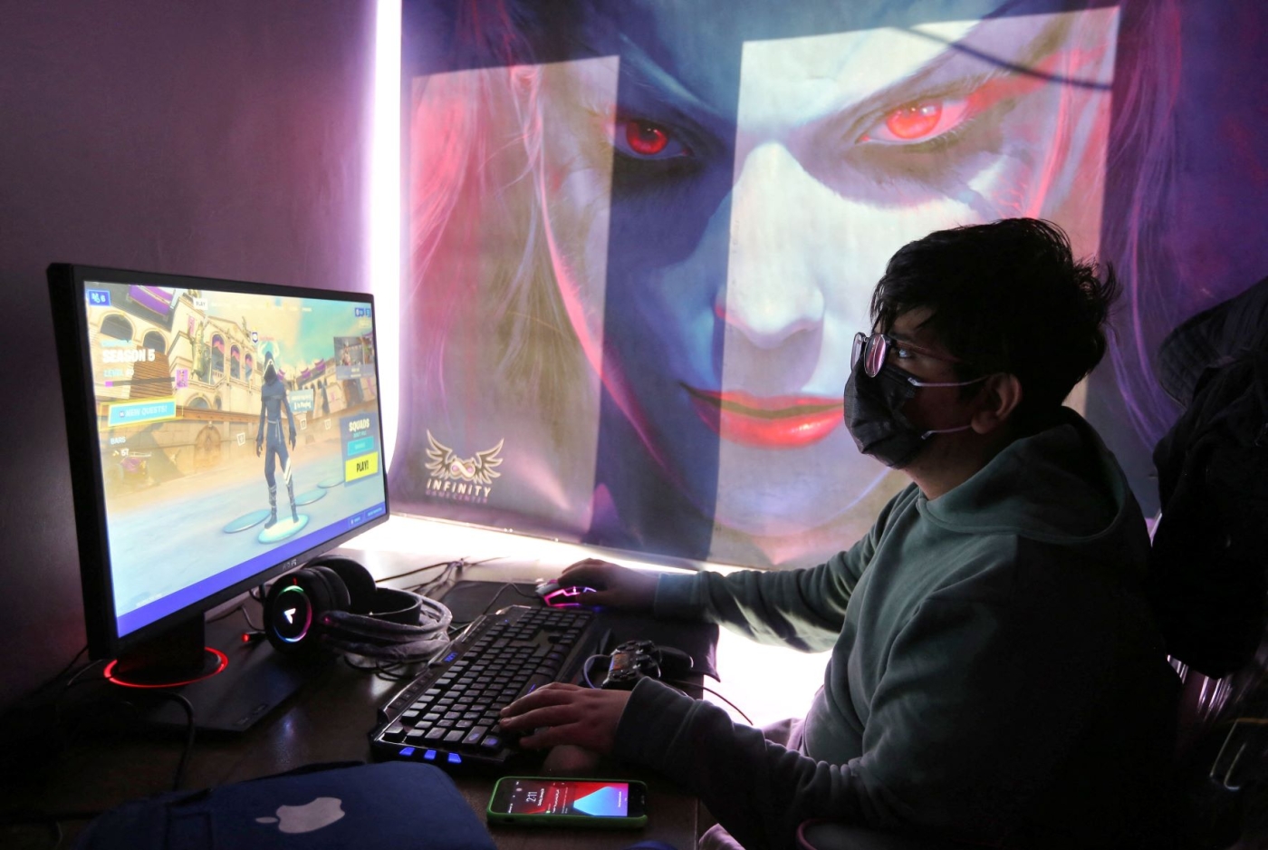 A youth plays an online multiplayer game at an internet cafe in Iran's capital Tehran on January 24, 2021 (AFP)