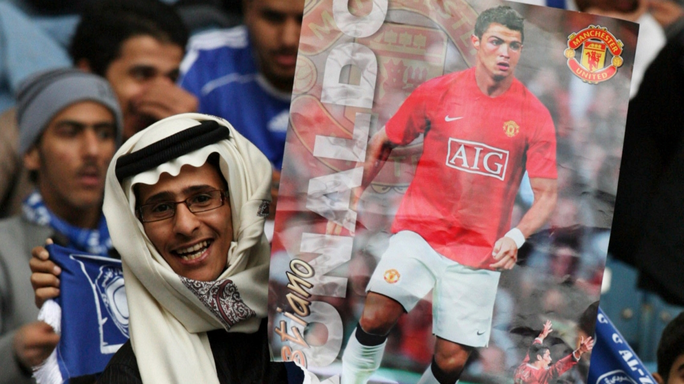 A fan holds up a poster of Manchester United's Cristiano Ronaldo at king Fahed international stadium in Riyadh on 21 January 2008 during a friendly match against Saudi club Al Hilal (Reuters)