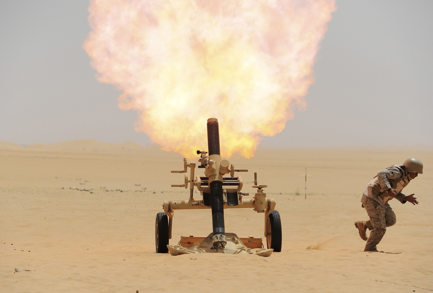 A Saudi soldier fires a mortar towards Houthi movement position, at the Saudi border with Yemen (Reuters)