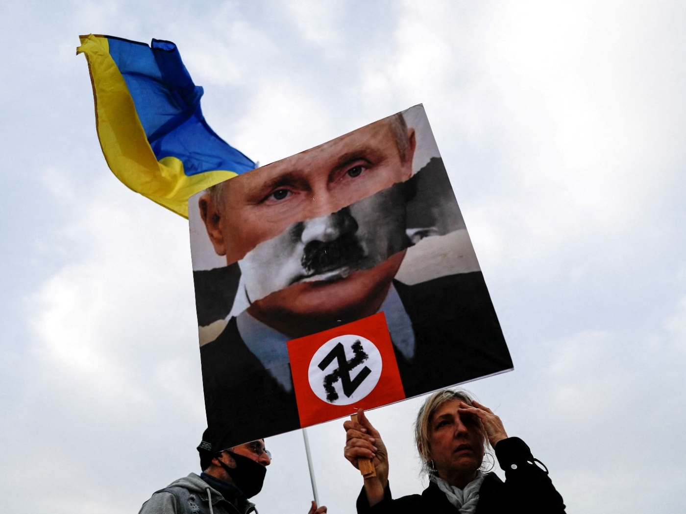 A protestor in Tel Aviv holds up a sign at a demonstration in support of Ukraine following Russia's invasion (Reuters)