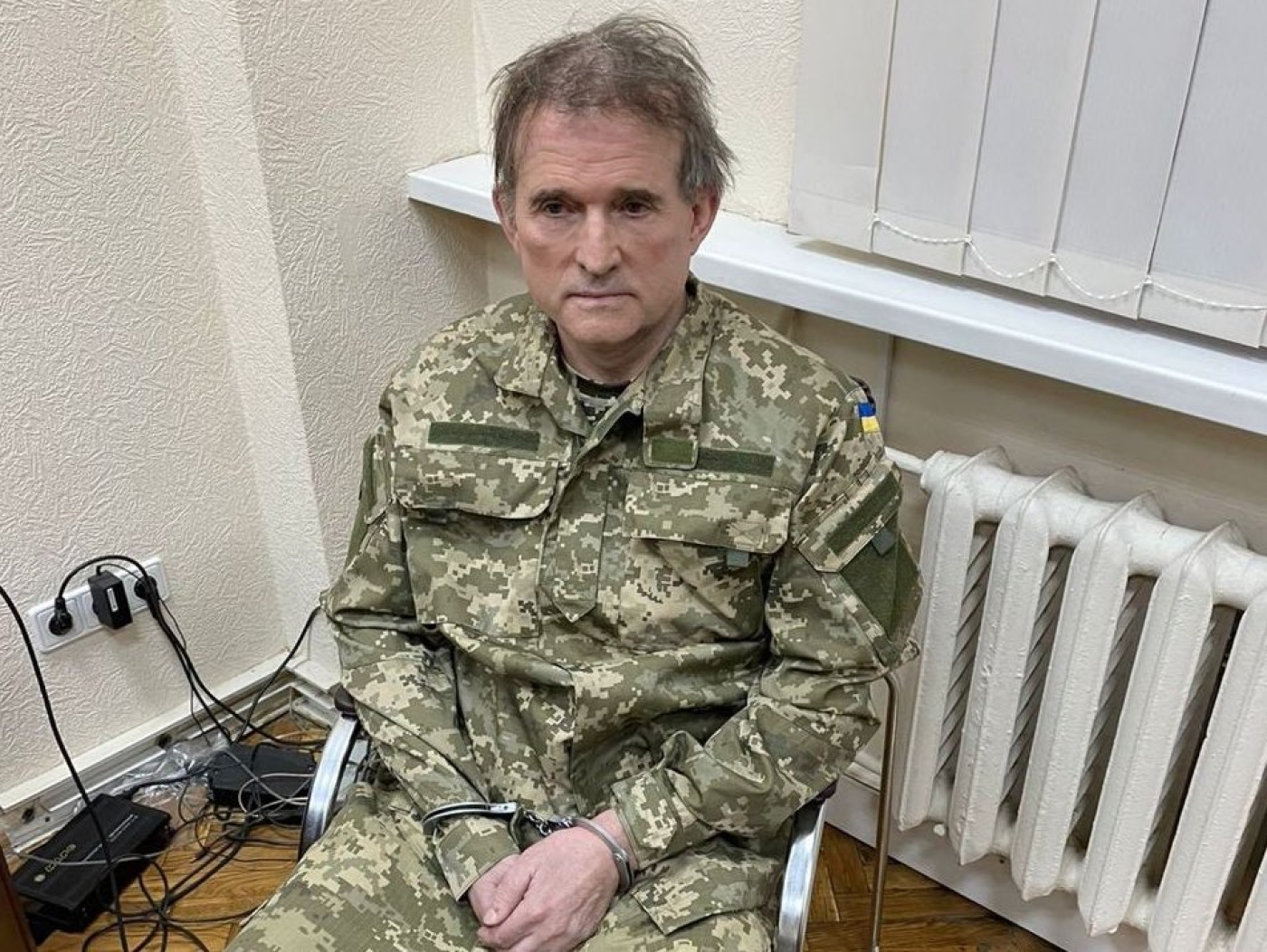 Pro-Russian Ukrainian politician Viktor Medvedchuk in handcuffs after he is arrested by an operation of Ukraine security forces on 12 April (Reuters)