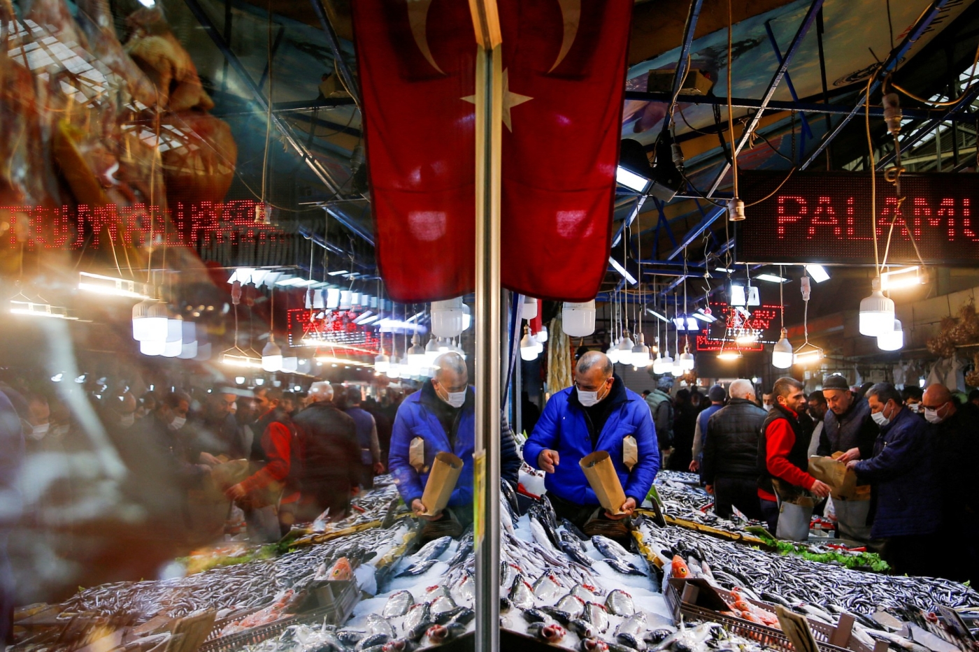 A vendor selling seafood serves customers in Ankara, Turkey. Food prices have doubled over the past year (Reuters)