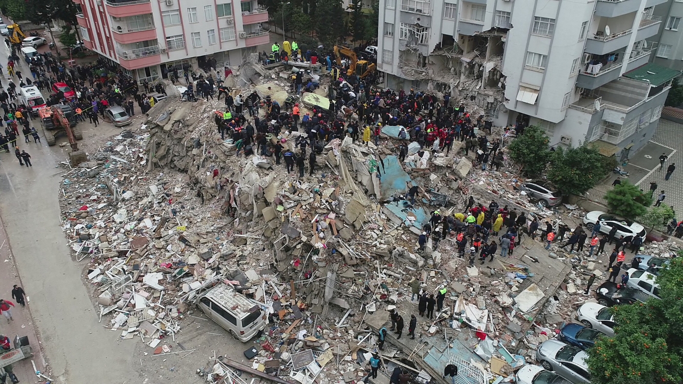 People search through rubble following an earthquake in Adana, Turkey on 6 February 2023 (Reuters)