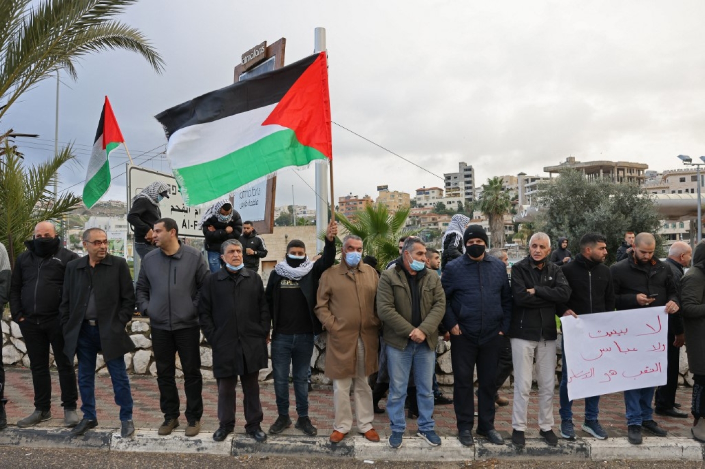 Arab Israelis shout slogans and wave Palestinian national flags in the mostly Arab city of Umm al-Fahm in northern Israel in solidarity with Bedouin communites in the Negev Desert, on January 14, 2022