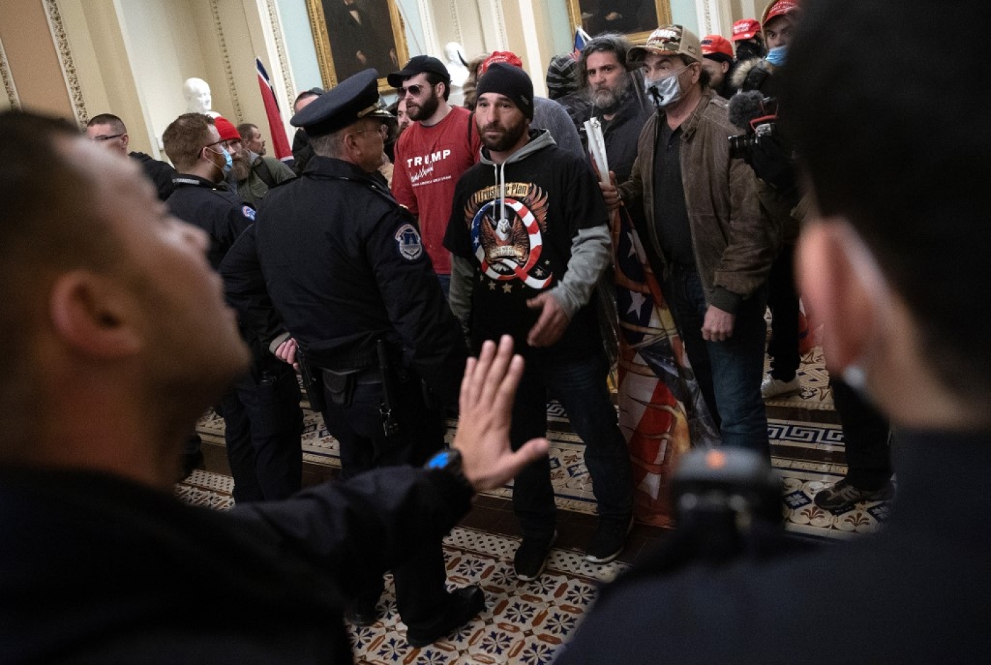 Trump-supporting mob confronts US Capitol police after storming the building on 6 January 