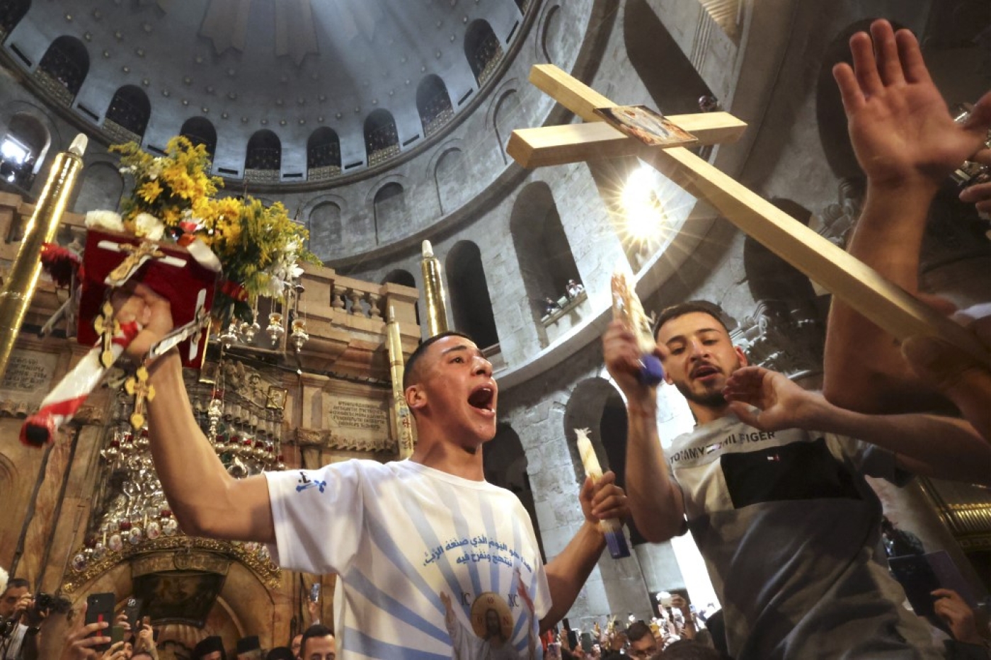 Christians gather around the Edicule, traditionally believed to be the burial site of Jesus Christ, during the Holy Fire ceremony at Jerusalem's Holy Sepulchre church, on 23 April 2022 (AFP)