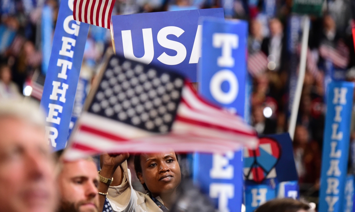 A woman waves a flag at the Democratic National Convention
