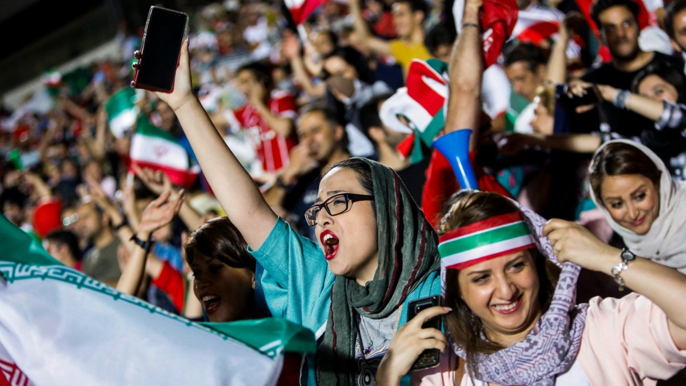 Iranian football supporters wave their national flag during a match between Iran and Spain in Azadi stadium in the capital Tehran on 20 June, 2018 (AFP)