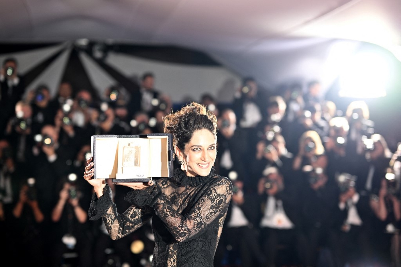 Iranian actress Zar Amir Ebrahimi poses with her best actress trophy during the closing ceremony of the 75th edition of the Cannes Film Festival in southern France, 28 May 2022 (AFP)