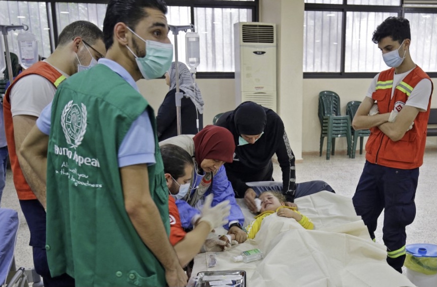 Medical staff treat a child with cholera at a ward in a mosque converted into a hospital in Bebnine, northern Lebanon, 26 October 2022 (AFP)