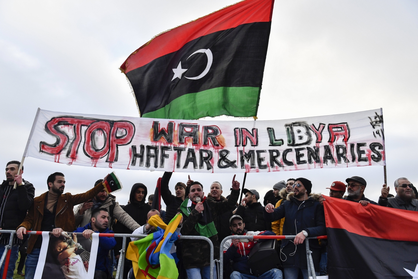 Protesters hold a banner reading 'Stop war in Libya, Haftar and mercenaries' during a protest near the chancellery during the Peace summit on Libya at the Chancellery in Berlin on 19 January, 2020.