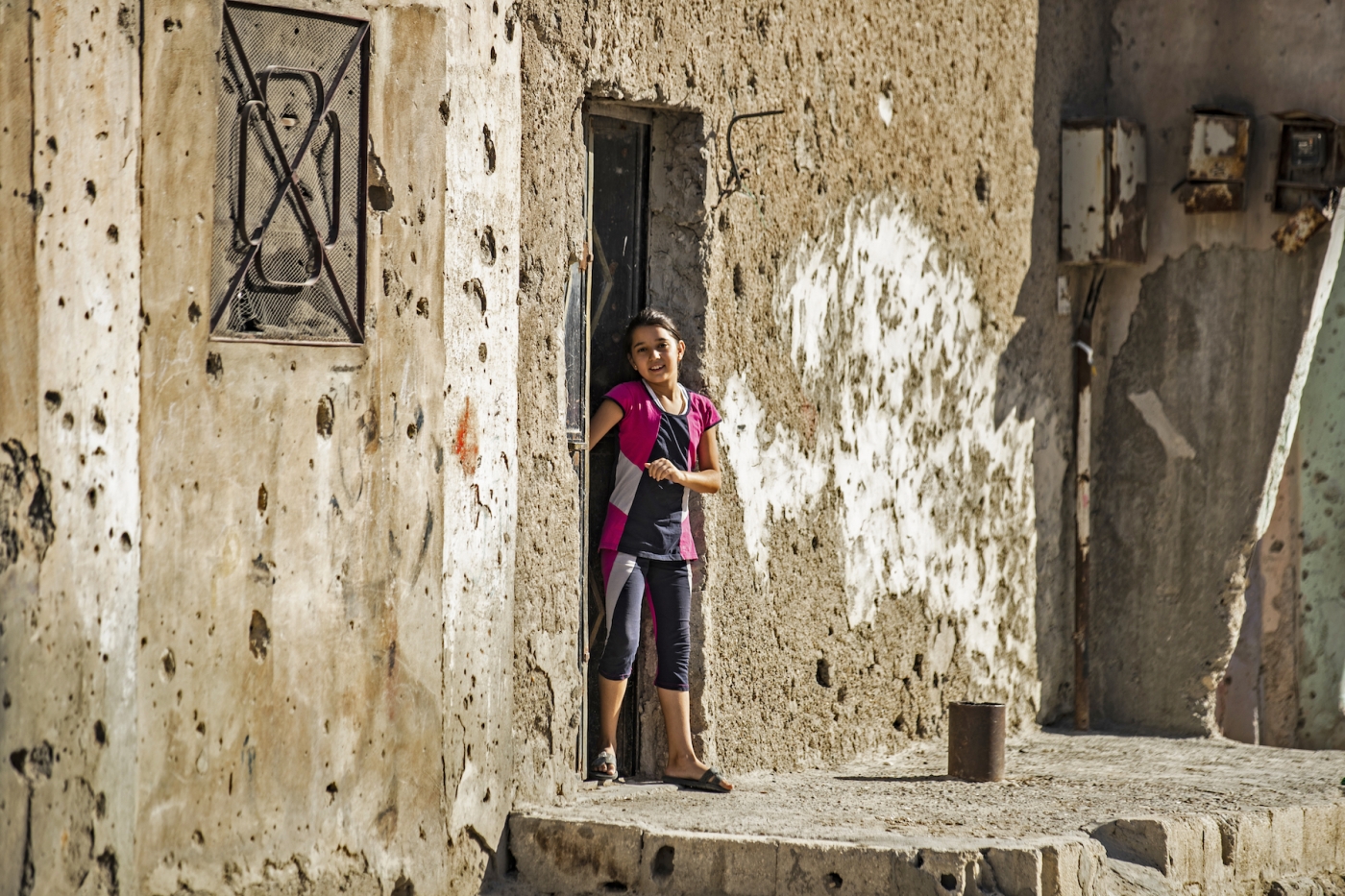 Girl outside house in Raqqa, Syria