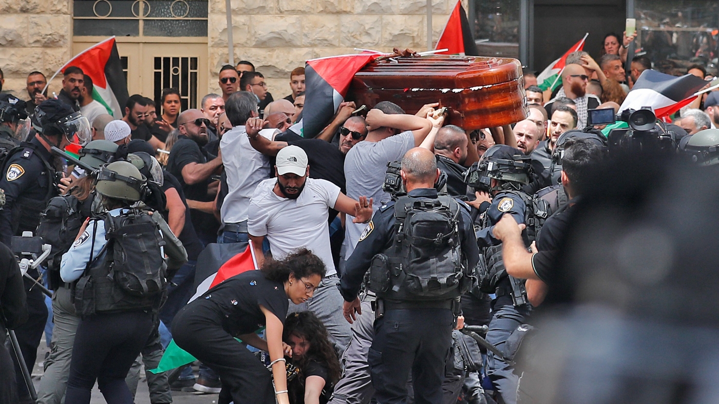 Mourners carrying the casket of Al-Jazeera journalist Shireen Abu Akleh out of a hospital, before being transported to a church and then her resting place, in Jerusalem, on May 13. (AFP)
