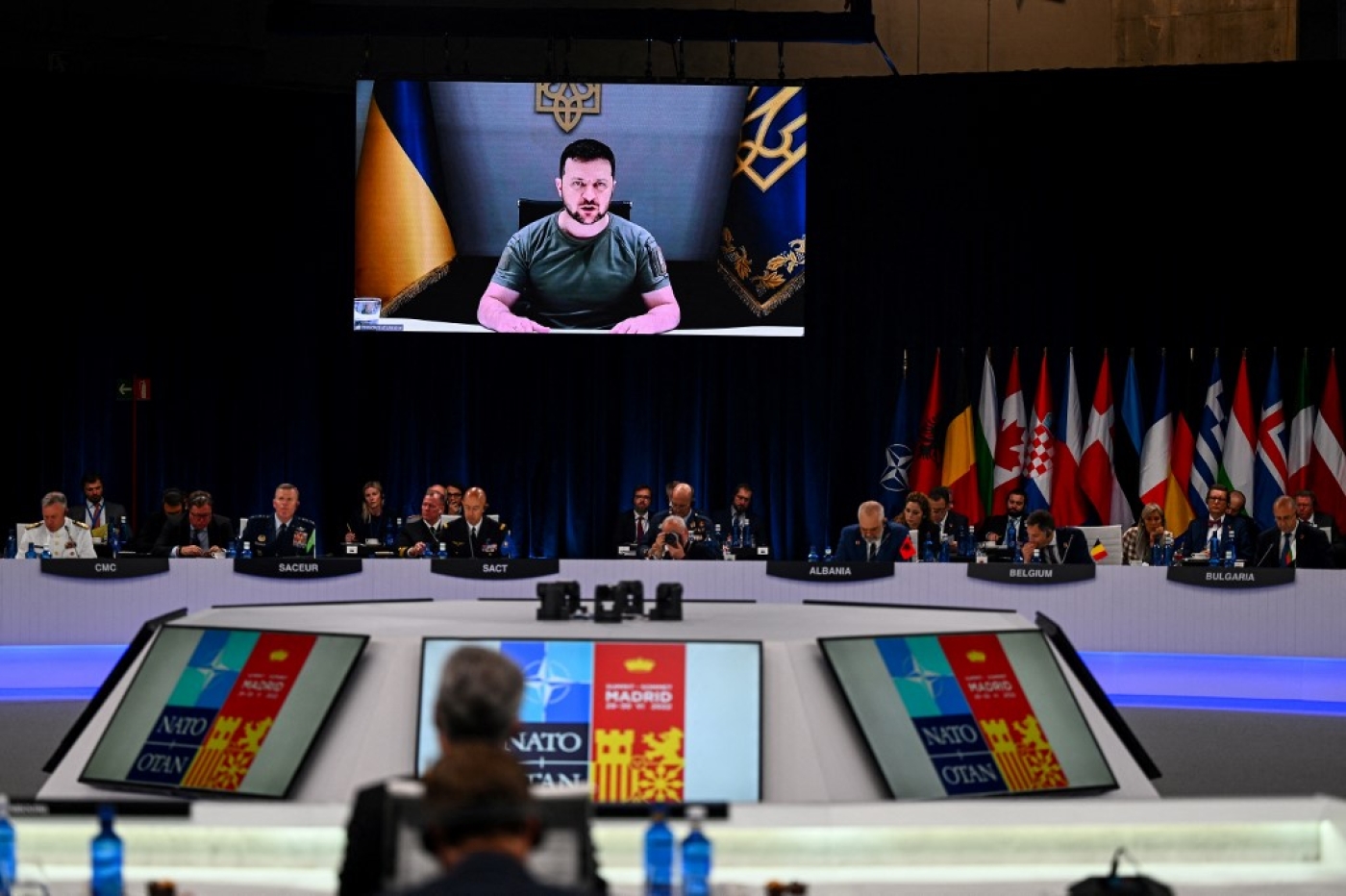 Ukraine's President Volodymyr Zelensky appears on a giant screen as addresses a Nato summit in Madrid, 29 June 2022 (AFP)
