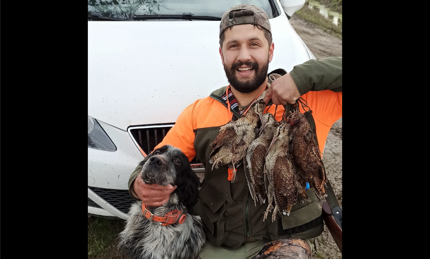 Ozgur Gevrekoglu, shot accidentally by his own dog, poses in a Facebook post with his pet and dead game birds (Facebook/Ozgur Gevrekoglu)