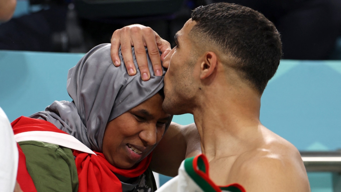 Morocco's Achraf Hakimi is greeted by his mother at the end of the Qatar 2022 World Cup Group F football match against Belgium at Al-Thumama Stadium in Doha on 27 November 2022 (AFP)