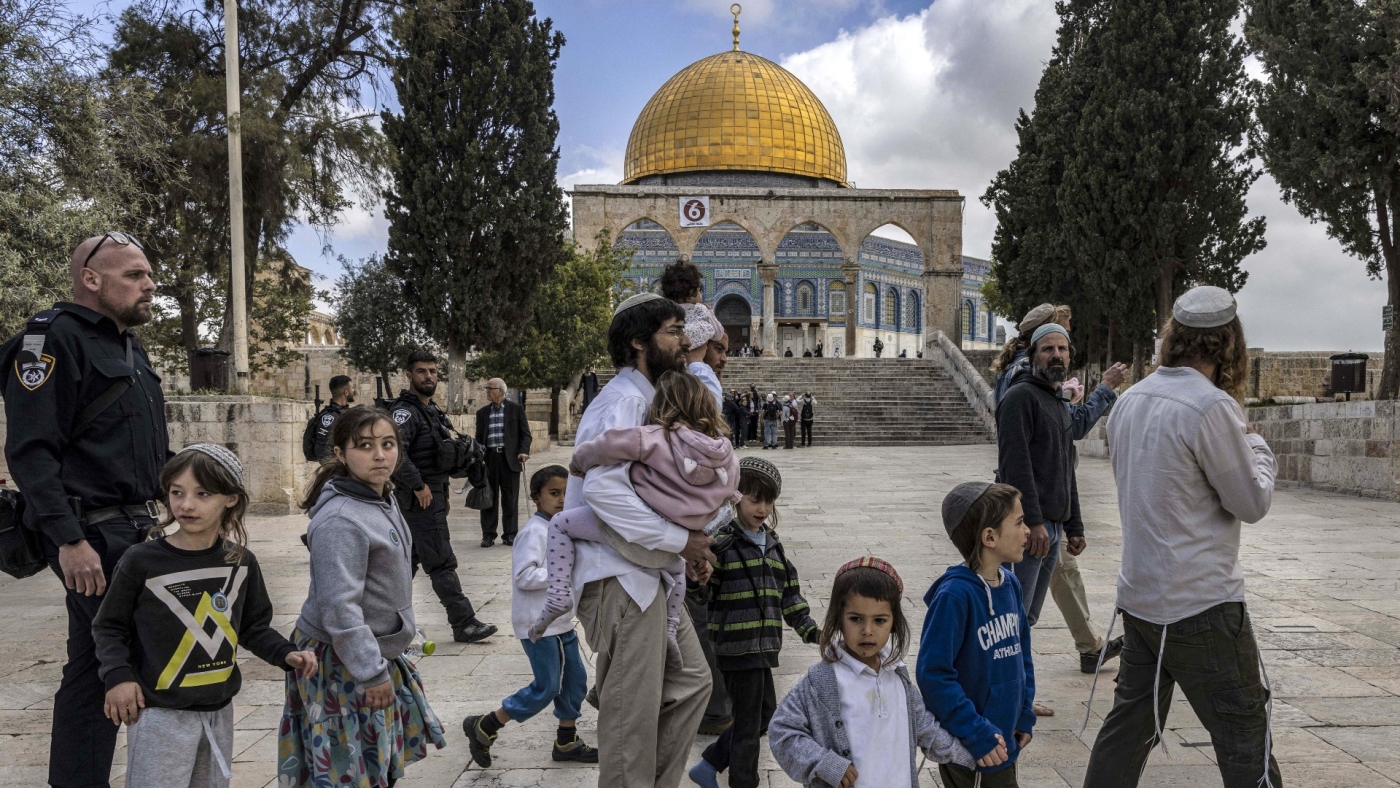 An Israeli security guard escorts Jewish visitors at the al-Aqsa mosque compound in the old city of Jerusalem on 20 April 2022 (AFP/File photo)