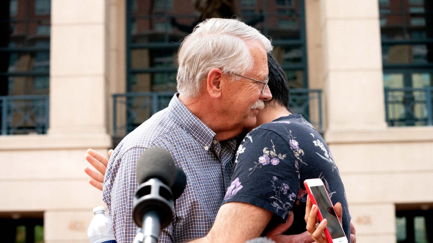 Carl Mueller, the father of Kayla Mueller, an American slain by Islamic State militants, embraces Rodwan Safer Jalani, a friend of Kayla’s, outside a federal courthouse in Virginia on 14 April 2022.