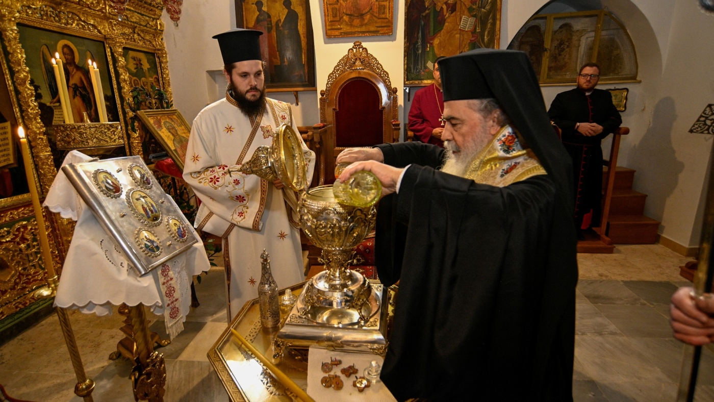 Greek Orthodox Patriarch of Jerusalem Theophilos III mixes the oils which will be used in the coronation of Britain's King Charles, in Jerusalem on 3 March 2023 (AFP)