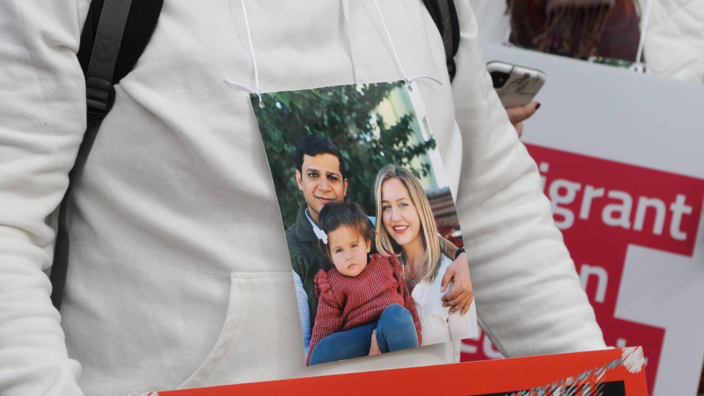 Danial wears a photo of his brother Afshin and his family, who have been barred from coming to the US because of Afshin's mandatory service in the IRGC.