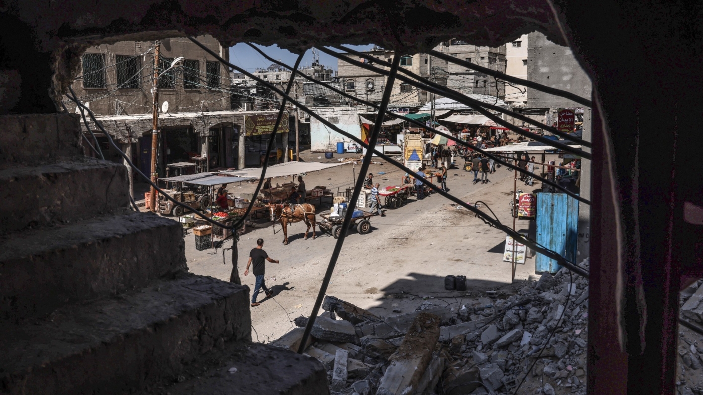 A street is seen on 30 September 2021, through a building destroyed by Israeli bombing last May, in Rafah in the southern Gaza Strip