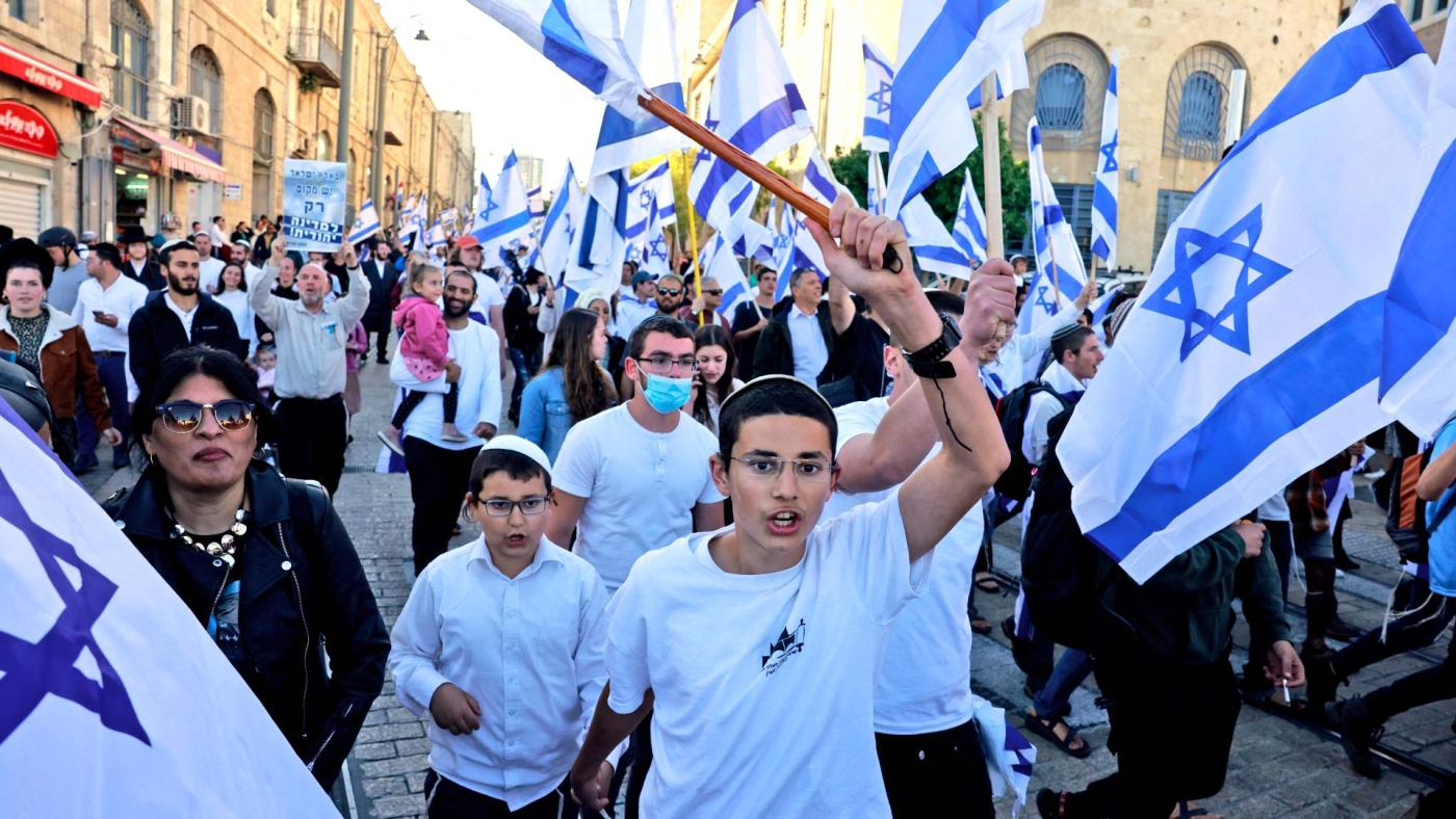 Far-right Israeli protesters wave national flags as they march toward Tzahal square on 20 April 2022.