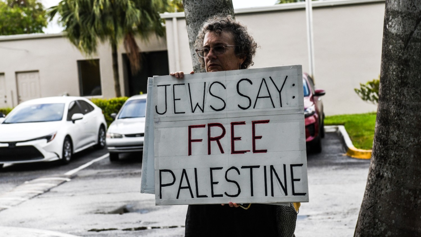 Members of Jewish Voice for Peace hold flags and placard as they protest outside the Duty Free Americas Headquarters in Hollywood, Florida on 2 June 2021.