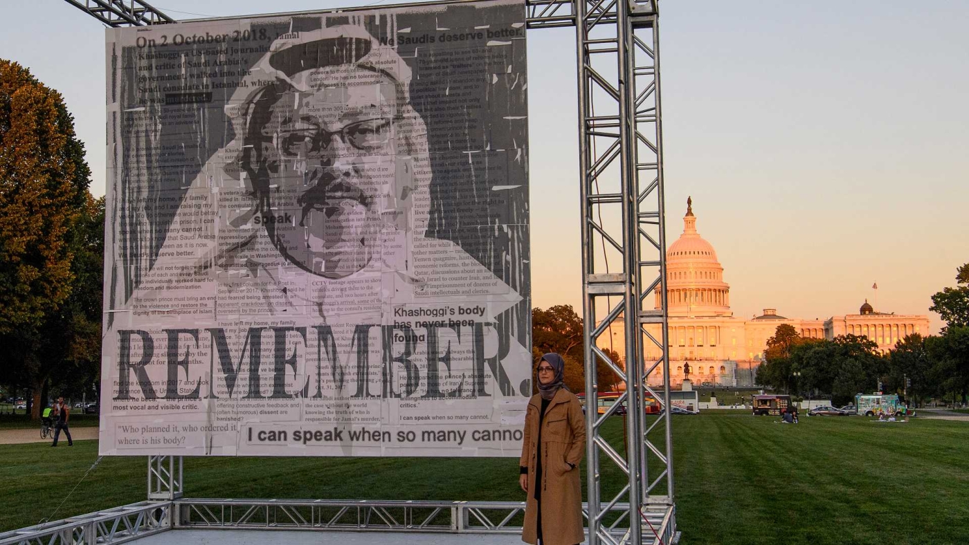 Hatice Cengiz (R), fiancee of murdered Saudi journalist Jamal Khashoggi, poses next to a portrait of him on the National Mall in Washington on 1 October 2021.
