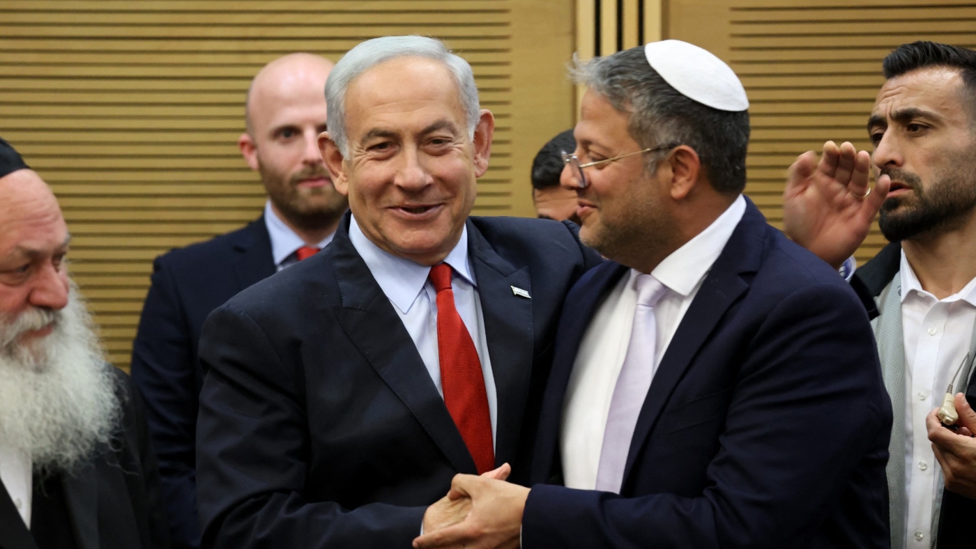 Israeli Prime Minister Benjamin Netanyahu greets National Security Minister Itamar Ben-Gvir, ahead of a vote on the national budget on 23 May 2023 at the parliament in Jerusalem (AFP)