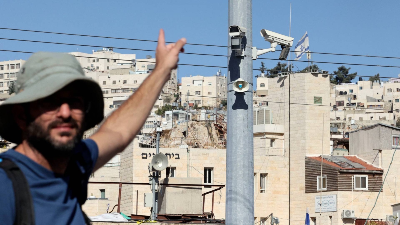 A man points at surveillance cameras in the Palestinian city of Hebron on 9 November 2021.