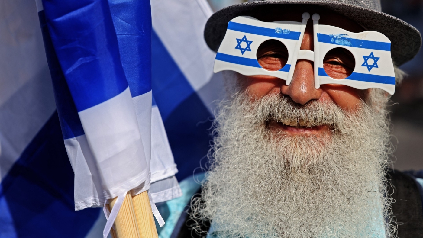 Israeli demonstrators prepare for the Flag March in Jerusalem on 29 May 2022 (AFP)