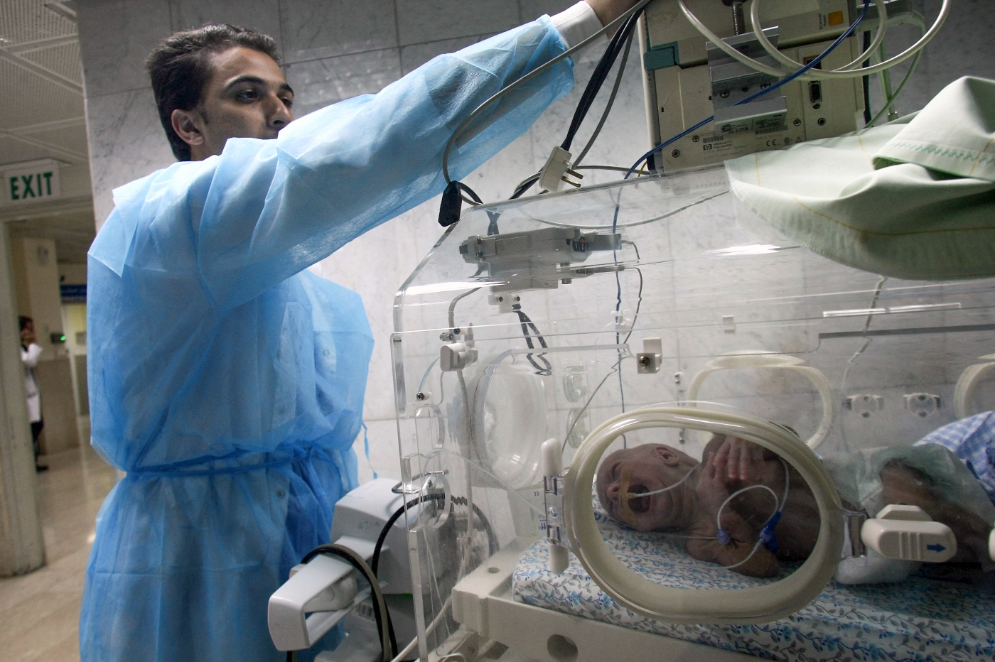 A Palestinian medic fixes the wires of a baby incubator at the al-Makassed in occupied East Jerusalem (AFP/file)