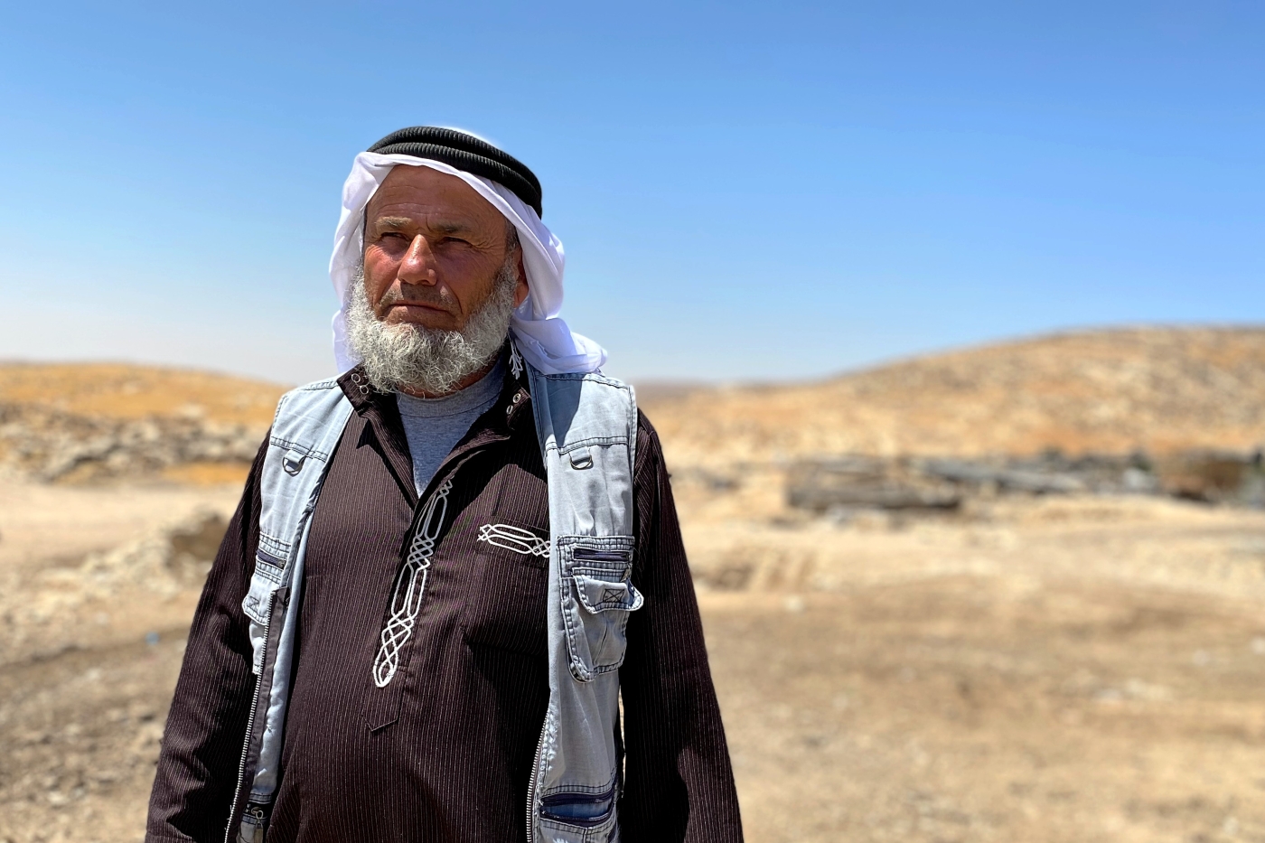 Ali Jabarin stands in Janba village in Masafer Yatta, a community of 2,500 Palestinians facing imminent expulsion by the Israeli army, on 19 June 2022. (MEE/Shatha Hammad)