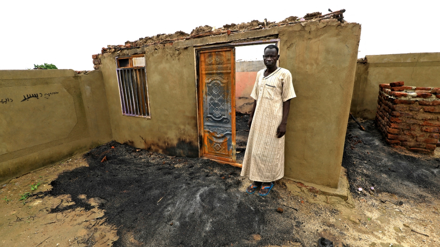 A man stands in a house destroyed as a result of tribal clashes in Roseires, in Sudan's Blue Nile state, some 450km south of Khartoum, on 8 August 2022 (AFP)