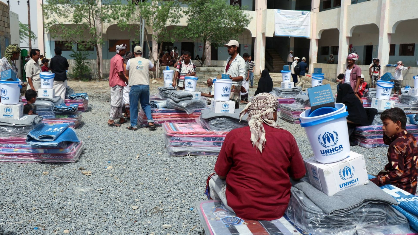 Displaced Yemenis receive humanitarian aid provided by the UN High Commissioner for Refugees in the northwestern province of Hajjah on 1 August 2021