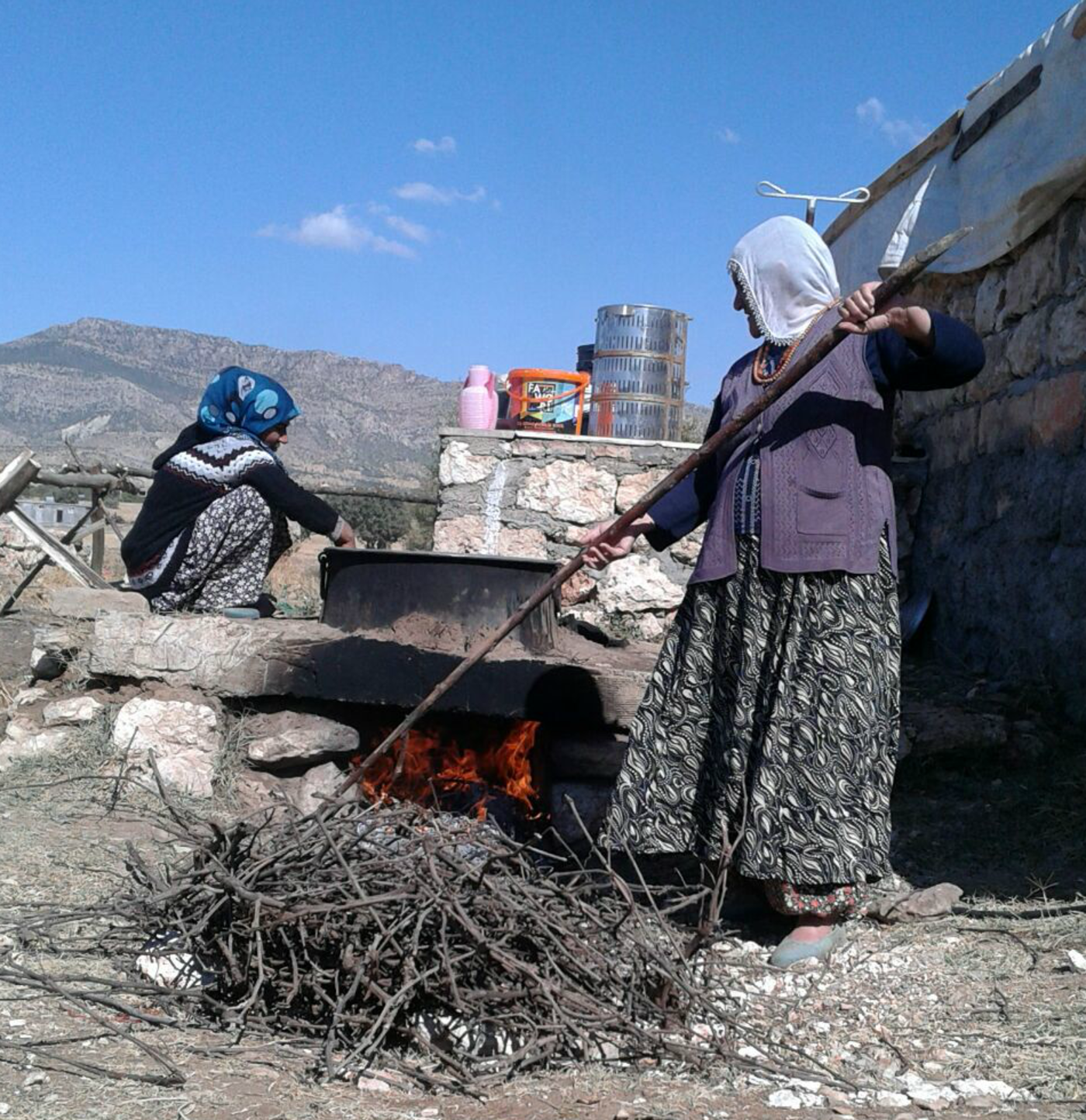 ​  Kurdish women hired by Hevsel Bahcesi cooking what eventually becomes fruit leathers with walnuts (Courtesy of Sehadet Citil)  ​