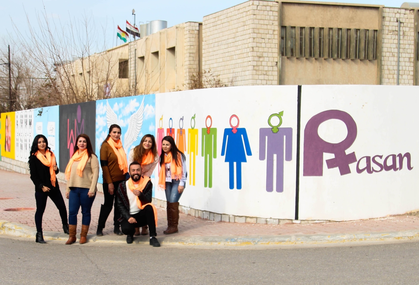 Activists from pro-LGBT group Rasan pose in front of murals in Sulemaniyah in 2018 (supplied)