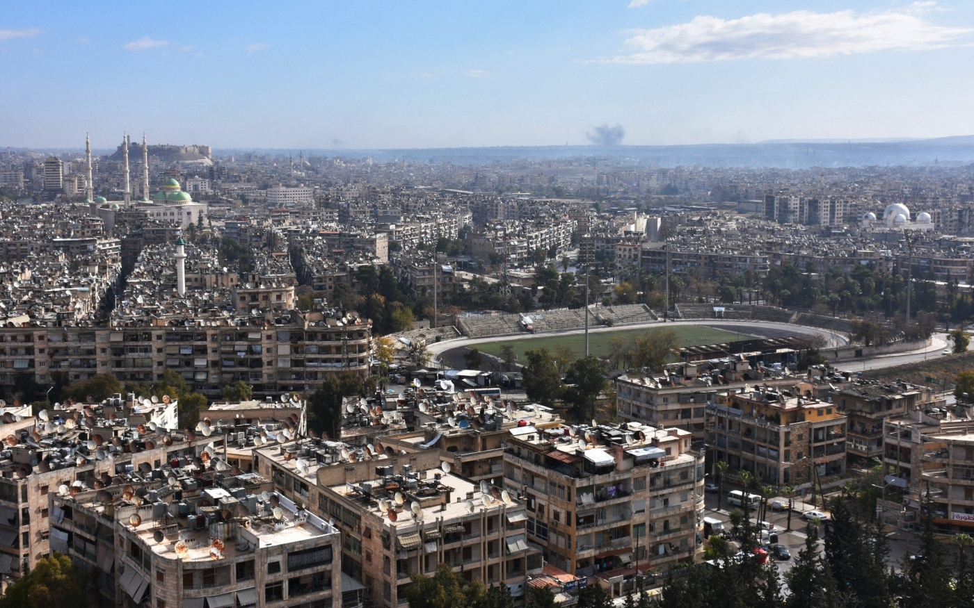 Vue de citadelle historique d’Alep et d’un stade municipal, alors que de la fumée s’élève en arrière-plan au cours de combats entre les forces gouvernementales syriennes et les combattants rebelles, le 3 décembre 2016 (AFP)