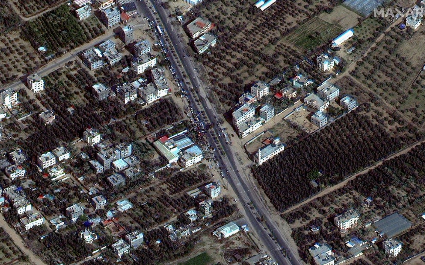 Cette image satellite fournie par Maxar Technologies montre des gens attendant du gaz le long de la route de Salah al-Din, dans la bande de Gaza, le 26 novembre 2023 (AFP)
