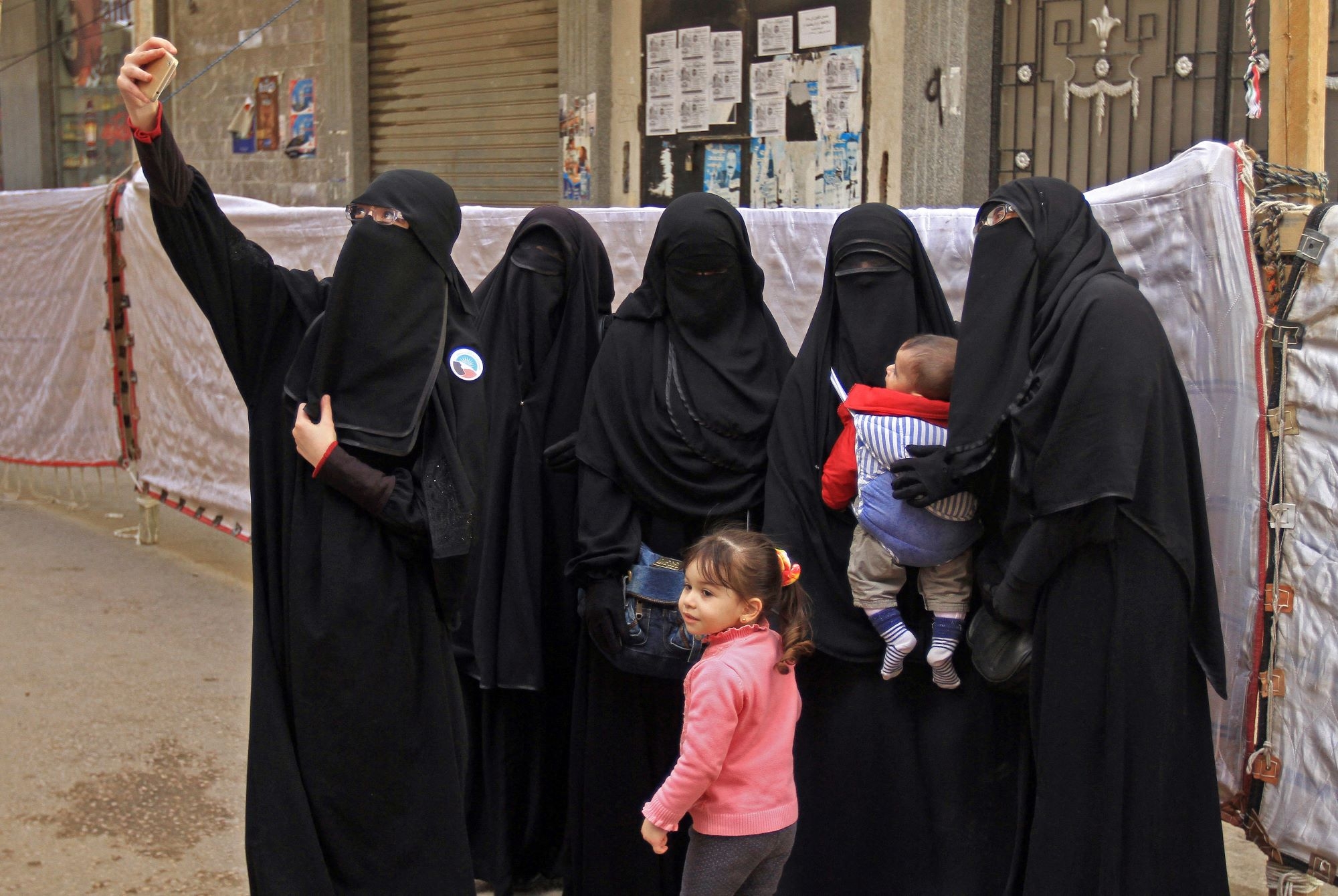 Egyptian women wearing niqabs pose for a photograph outside a polling station in Alexandria in 2018