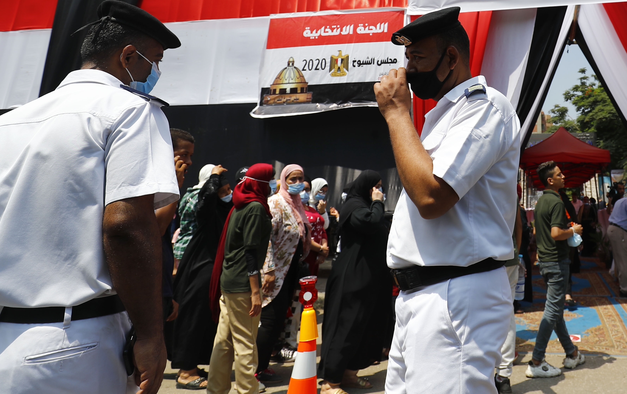 Egyptians queue up outside a polling station on August 11, 2020