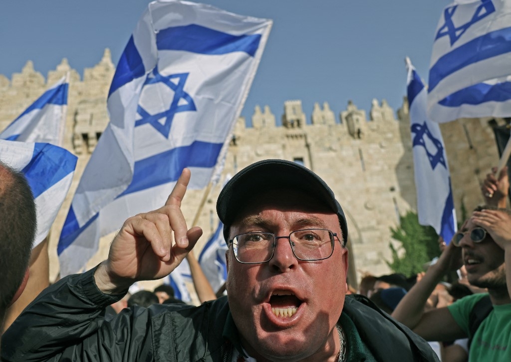 A demonstrator gestures during the far-right Israeli 'flags march' to mark "Jerusalem Day" outside the old city's Damascus Gate on 29 May 2022. (AFP)